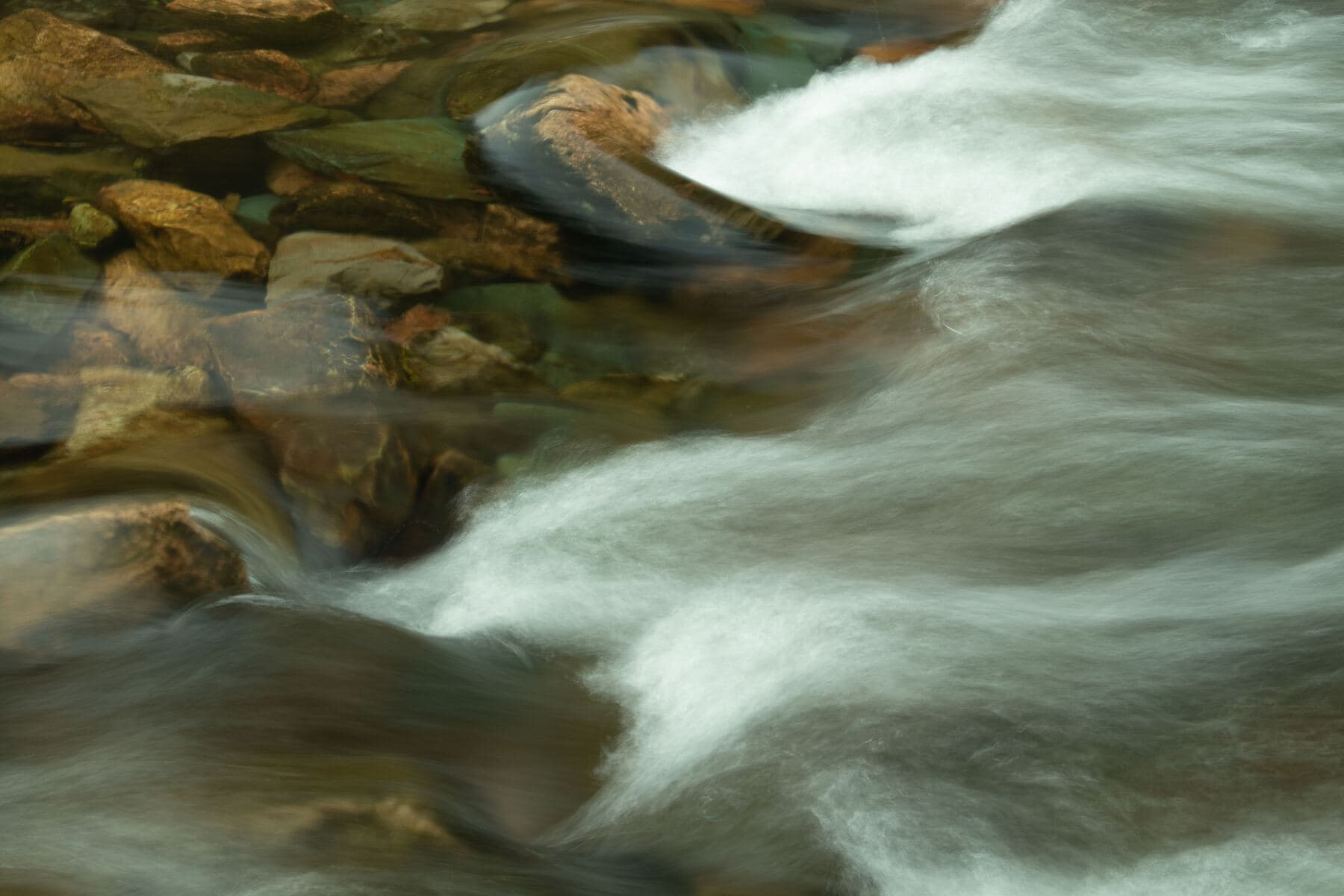 Close-up of flowing water over rocks in a stream